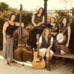 Sweet Yonder promo photo of music group consisting of 5 women with instruments, sepia toned