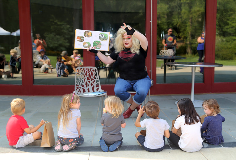 Drag queen performer reads a story to kids as part of Drag Story Hour program at Brookside Gardens. 