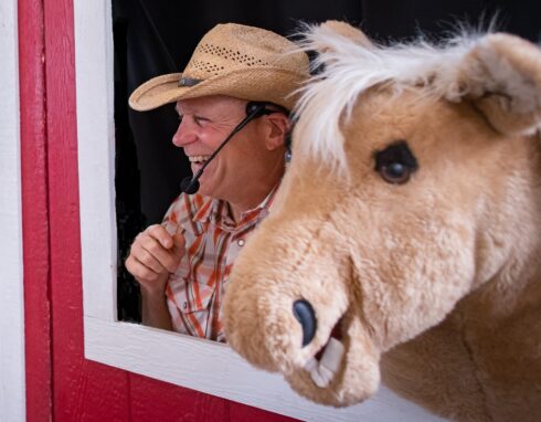kidsinger jim and henry the horse with their heads out the window of the barn