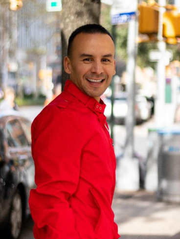 Pedro Gonzalez headshot in red shirt