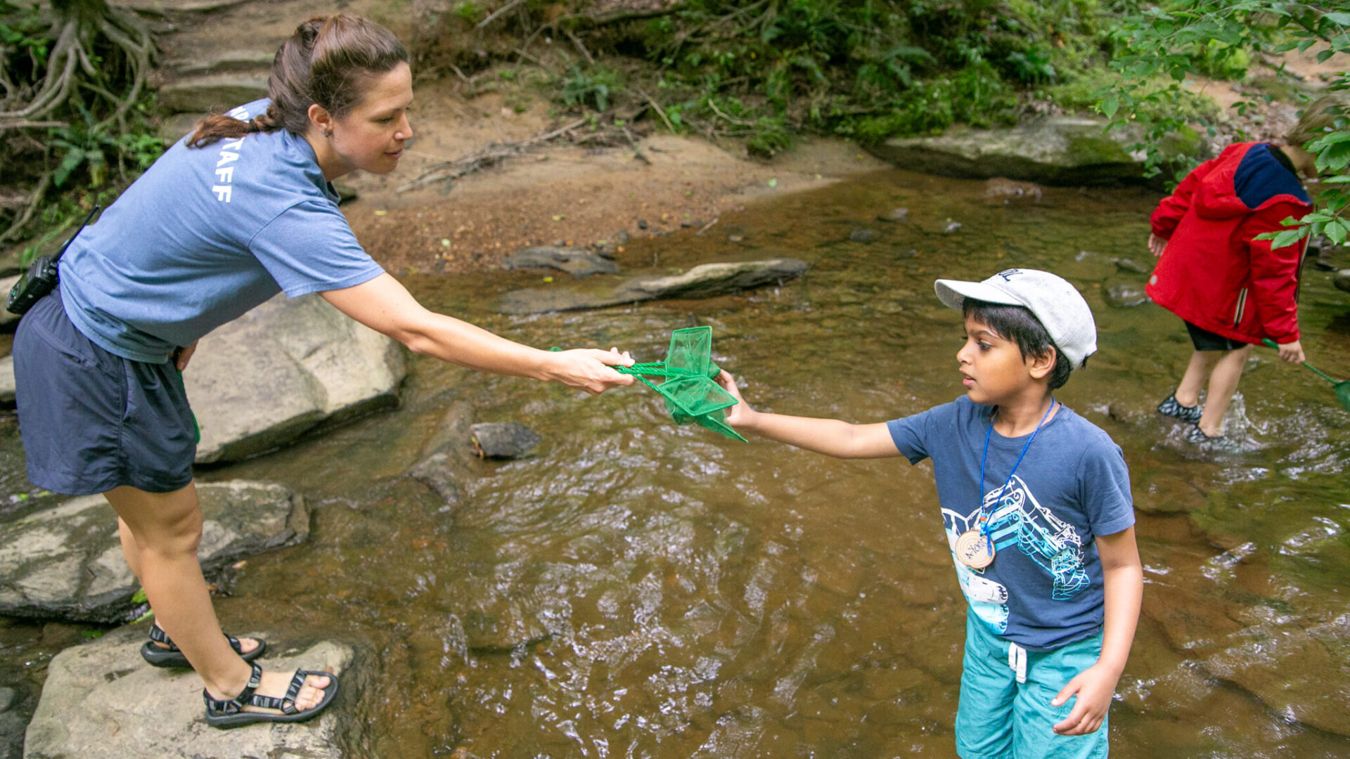 kids playing in stream at camp