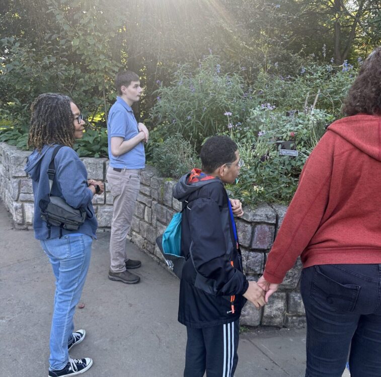 Group of trail trekkers observing flowers at brookside gardens
