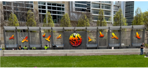 yellow and red birds flying from sphere gene lynch art contest gene lynch park