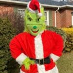 Person in Grinch costume with red and white coat and hat