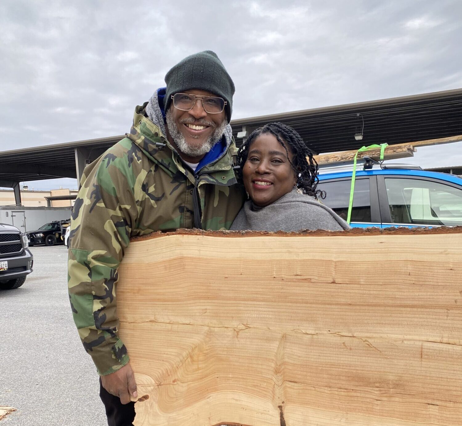 residents buying a slab of wood at urban wood sale