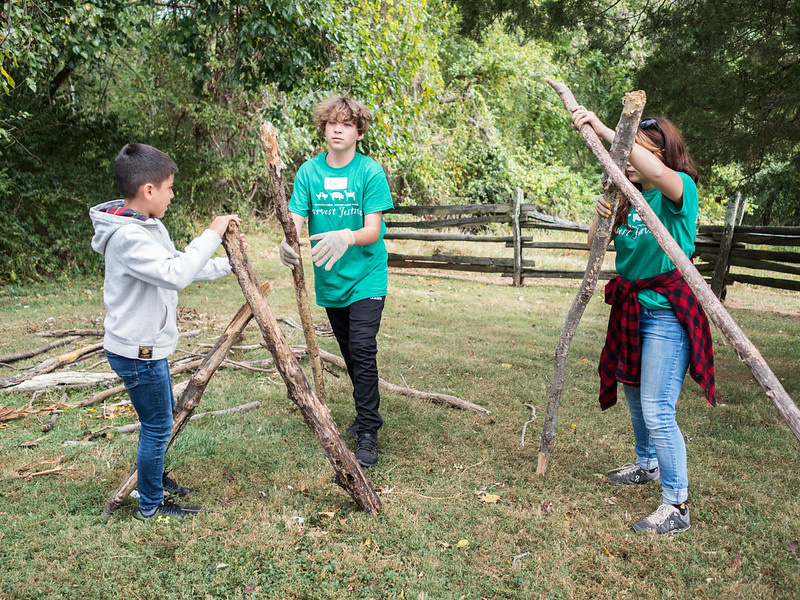 kids building shelter with sticks