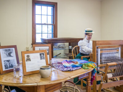 weaving with yarn at the ag history farm park