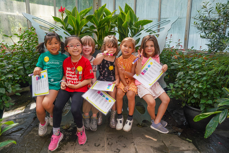 A group of young kids pose for a picture at the Brookside Gardens Conservatory