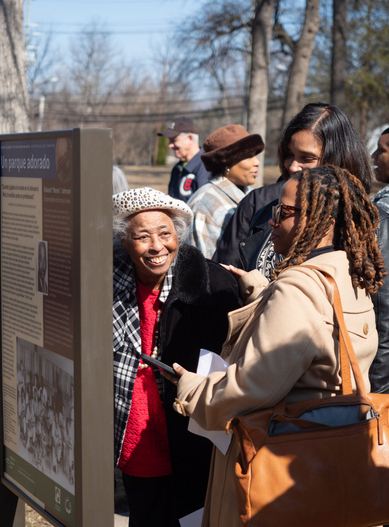 People standing by sign