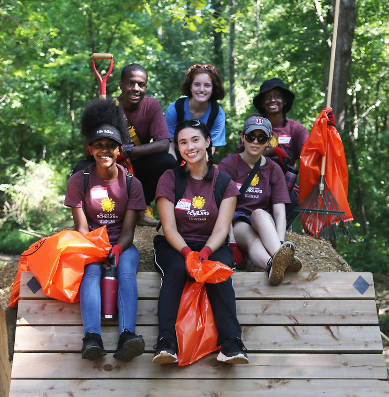 Group of student volunteers taking a group photo at a cleanup event.