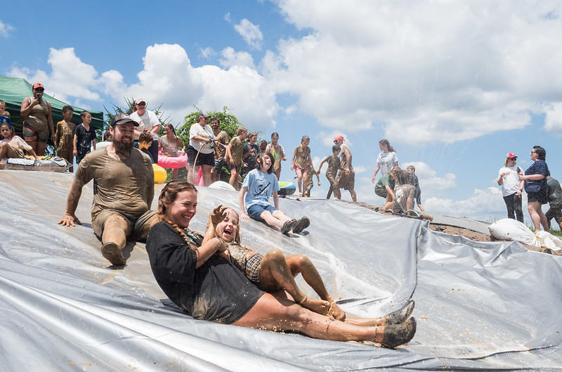 People slide down waterslide happily 