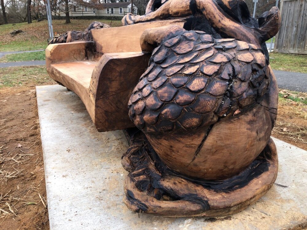 The side of the Linden Oak bench carving - acorn