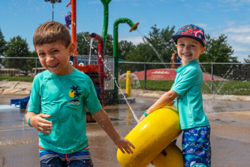 Two youth play with a water feature at South Germantown SplashPark
