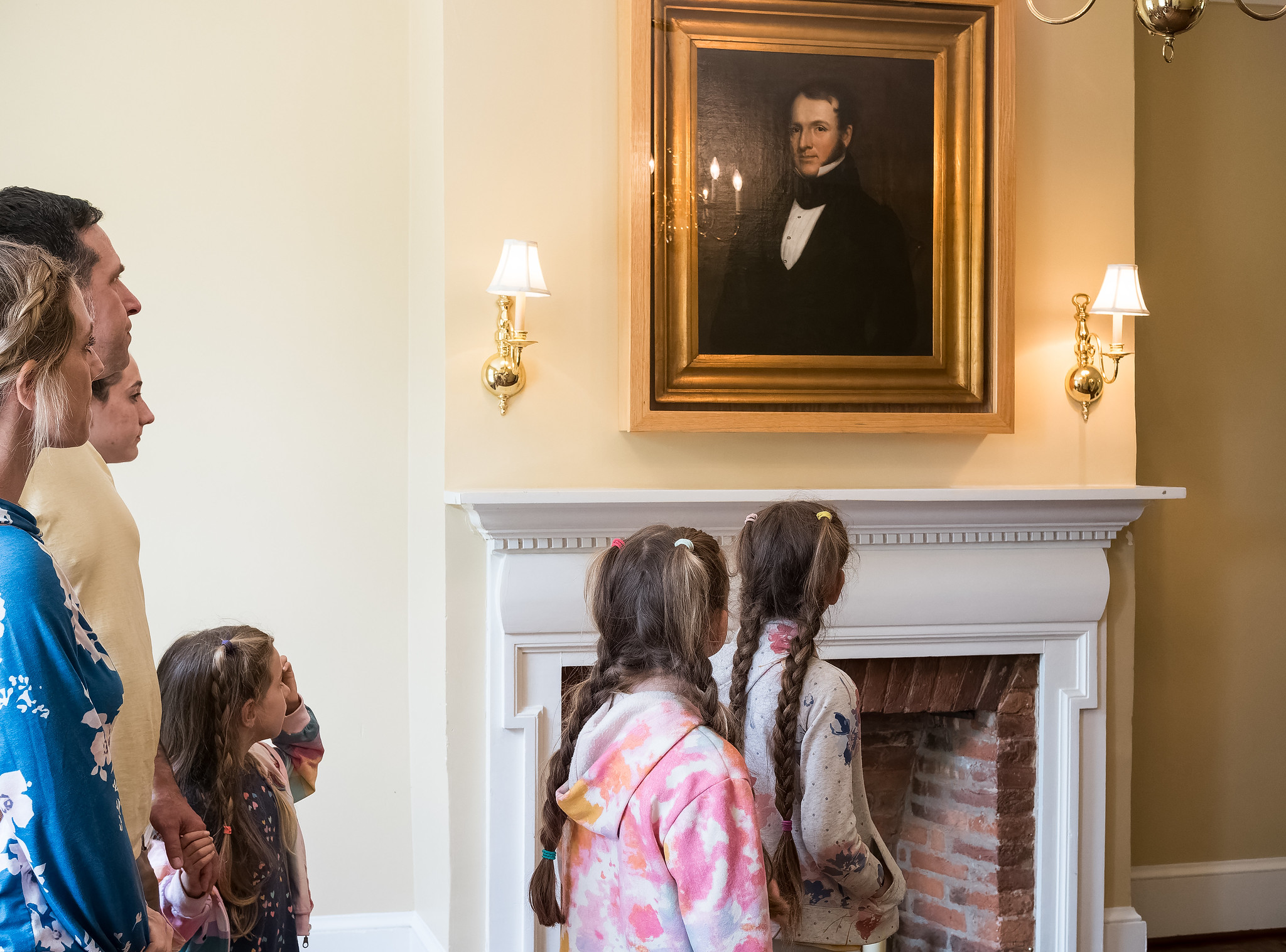 A group looks a portrait in Woodlawn Manor