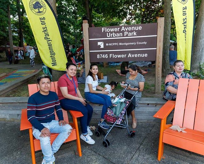 family and friends sitting next to the Flower Avenue Park at  acoustics and ales