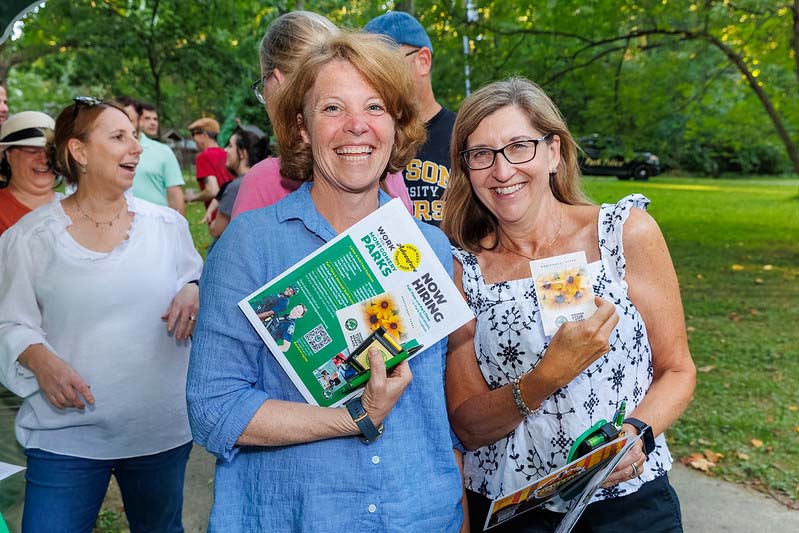 friends showing off their tickets at Montgomery parks  summer concert