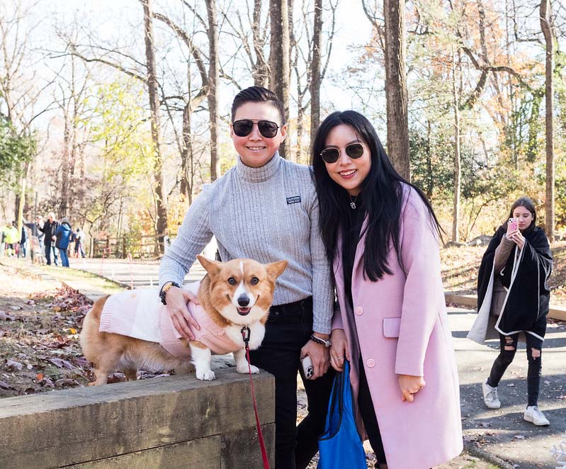 couple pose with their dog at Holiday Barket