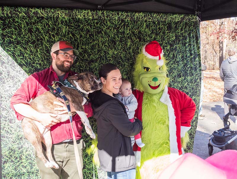 grinch and family with their dog take a photo together
