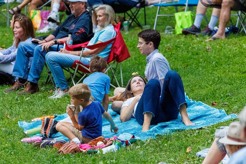 family laying in the grass at Montgomery parks  summer concert