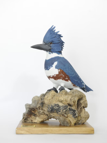 Painted wood carving of a bird.