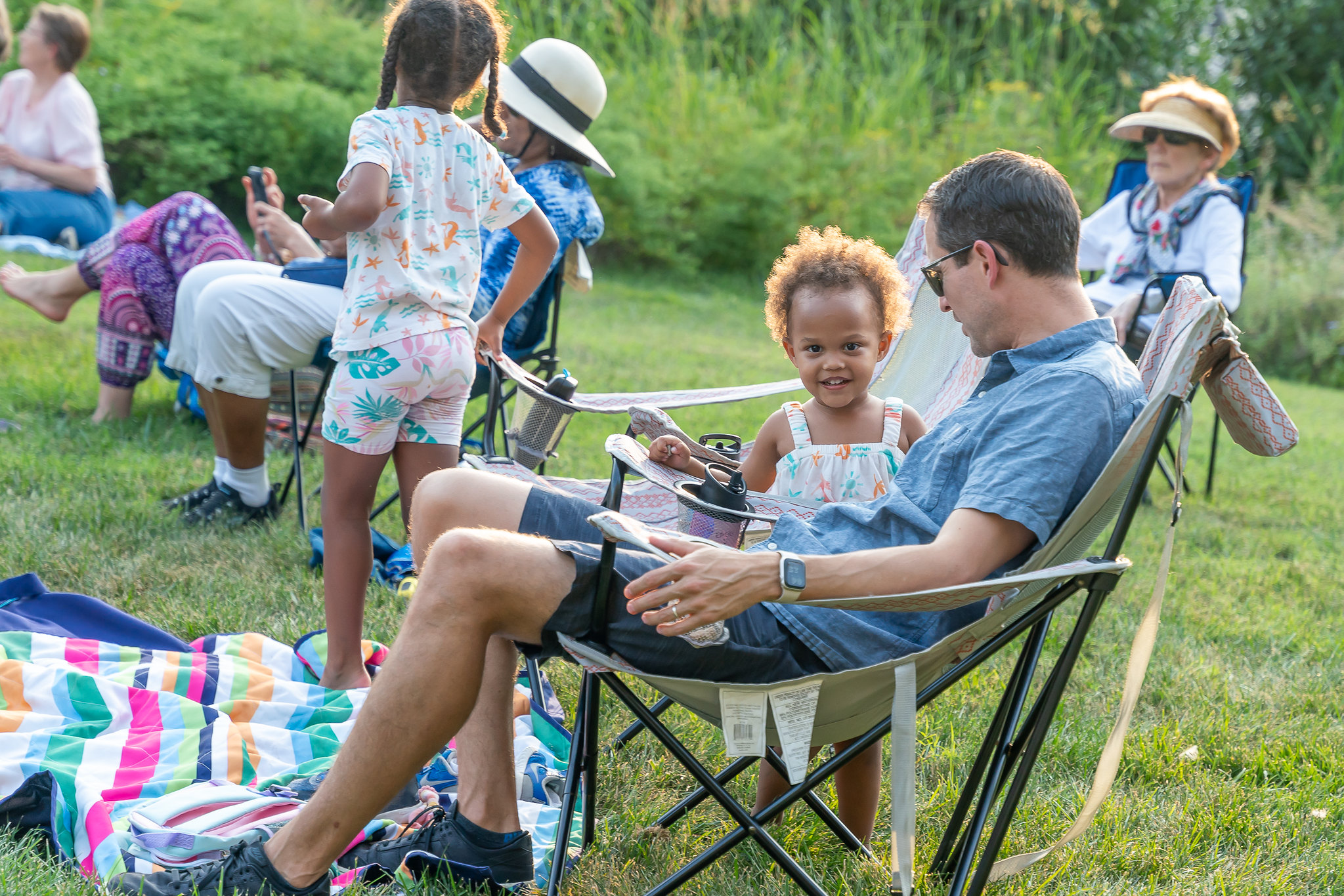 parent and child listening to music at brookside gardens.