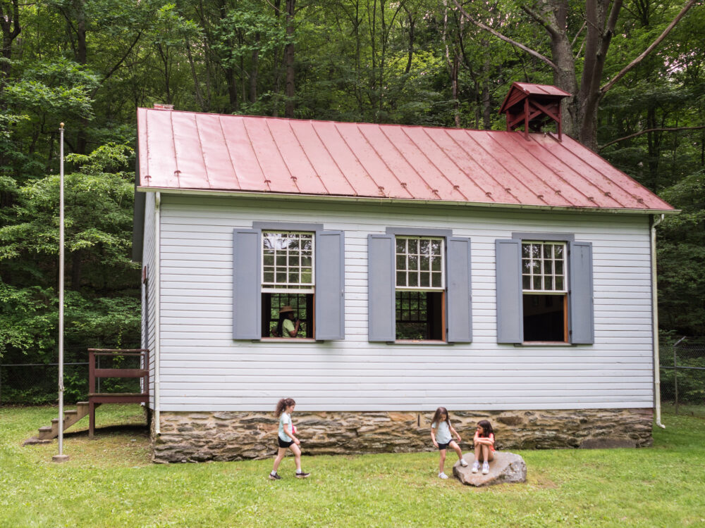 Kingsley Schoolhouse with kids outside