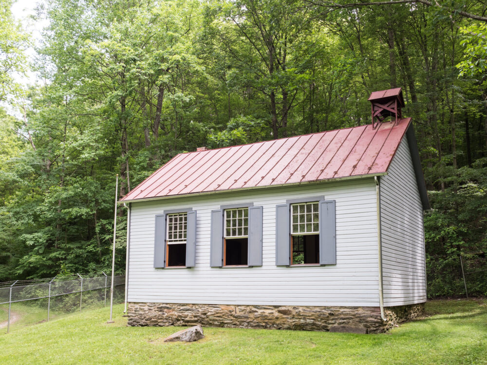 An outdoor view of Kingsley Schoolhouse and flagpole