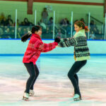 two girls spinning on the ice