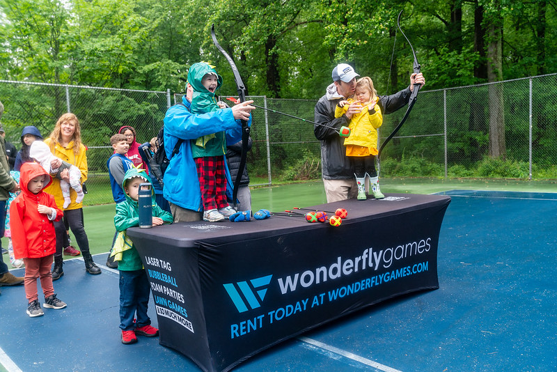 Kids playing Wonderfly games, shooting fake arrows