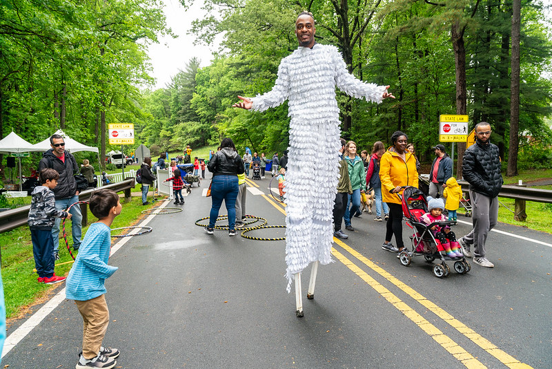 Stilt walker wearing white costume posing for camera