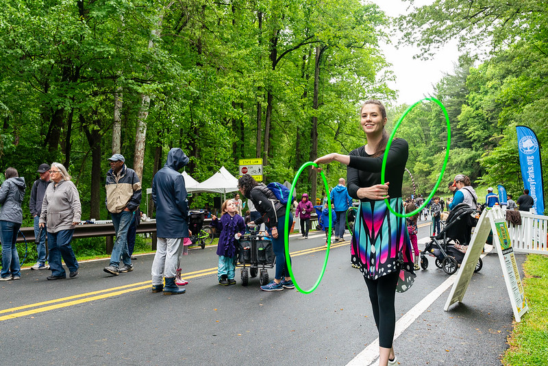 Hoola hoop artist in butterfly outfit on the parkway