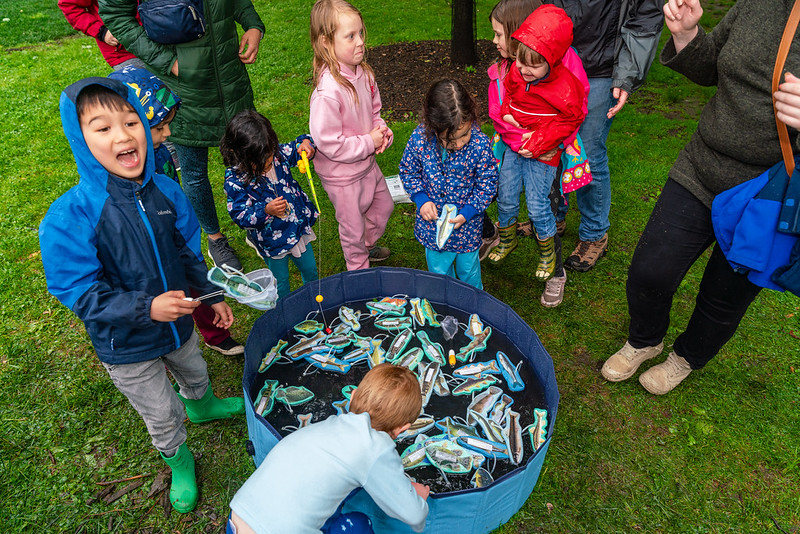 kids fishing for fake fish in tub