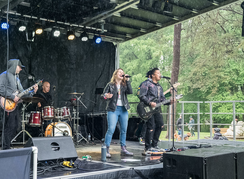 Band playing in the rain on stage