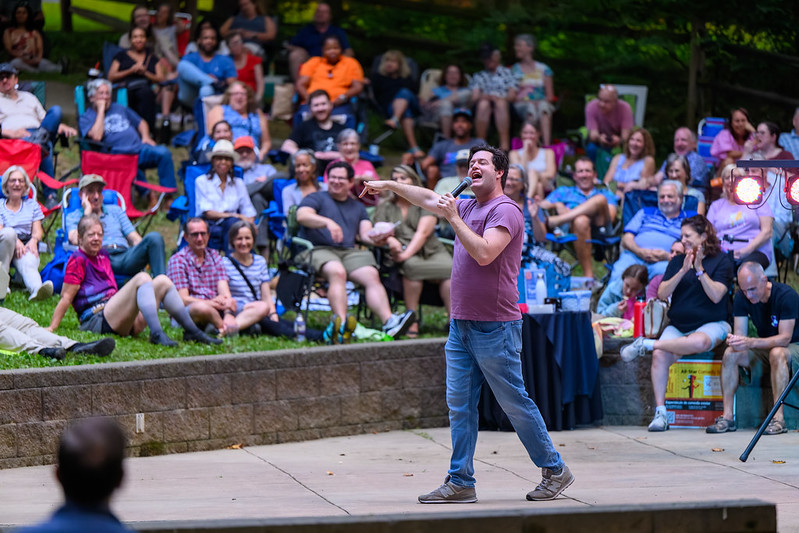 Performer interacting with crowd pointing while talking