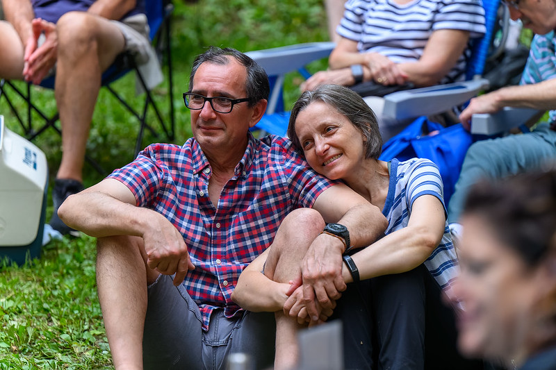 Couple holding hands and smiling watching comedians