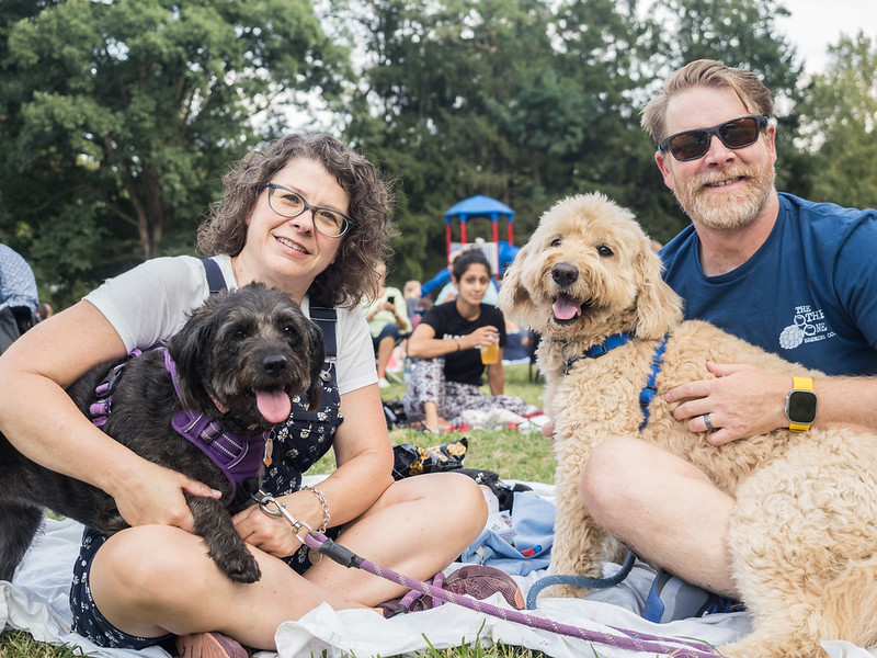 Couple with 2 small dogs enjoying a picnic at Acoustics and Ales September 2024