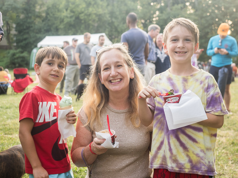 Mom and sons smile for the camera with ice cream in hand