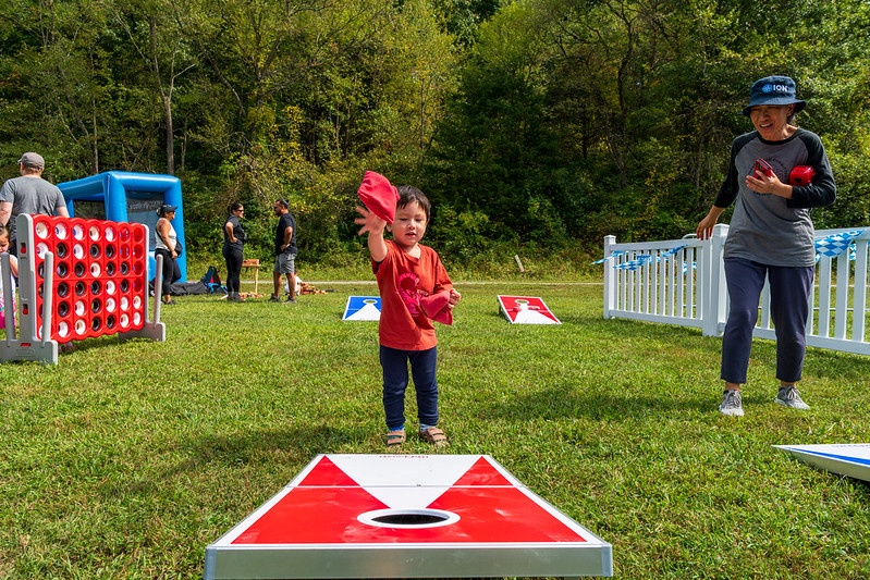 Young boy plays cornhole