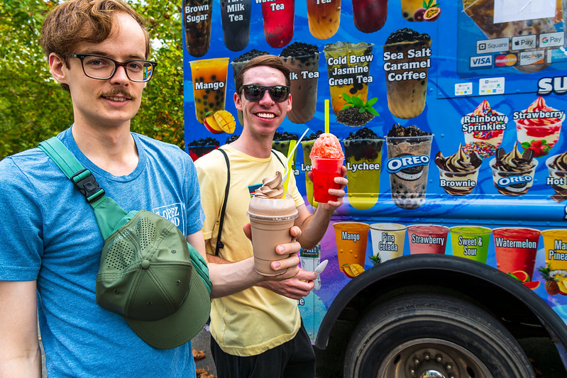 2 men with ice cream smiling by ice cream truck