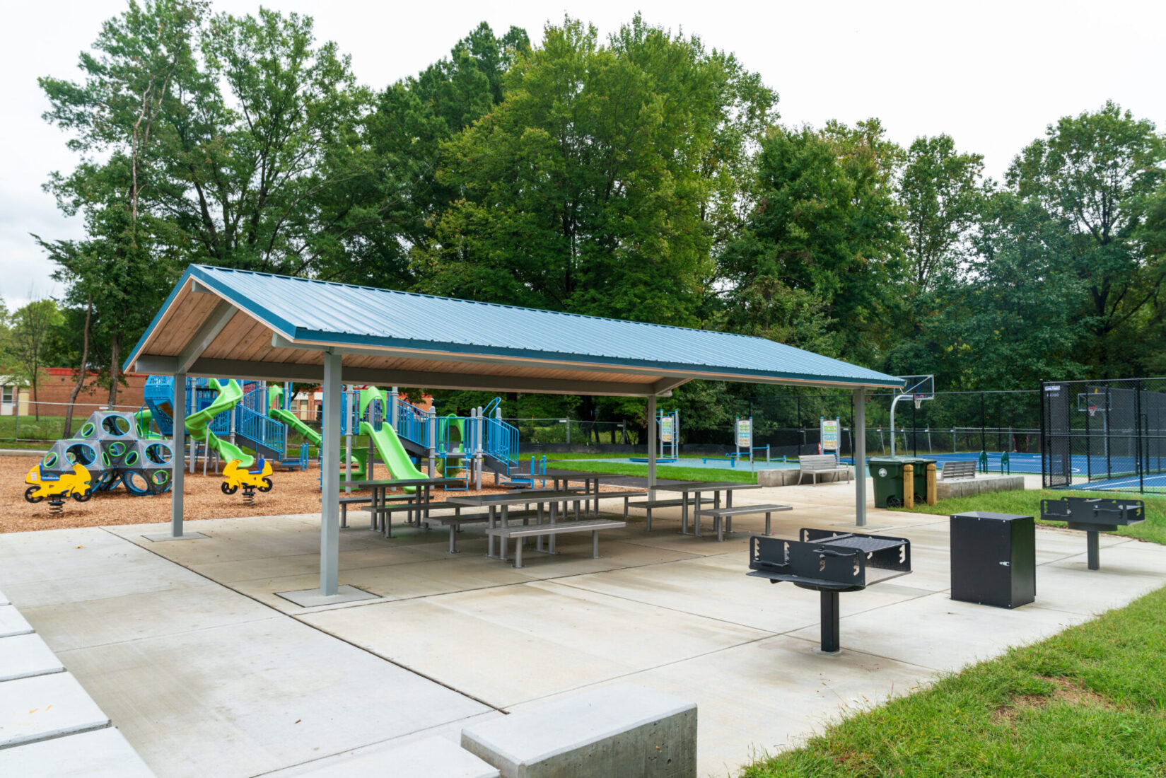 Strathmore Local Park shelter with tables and grills next to the playground and courts