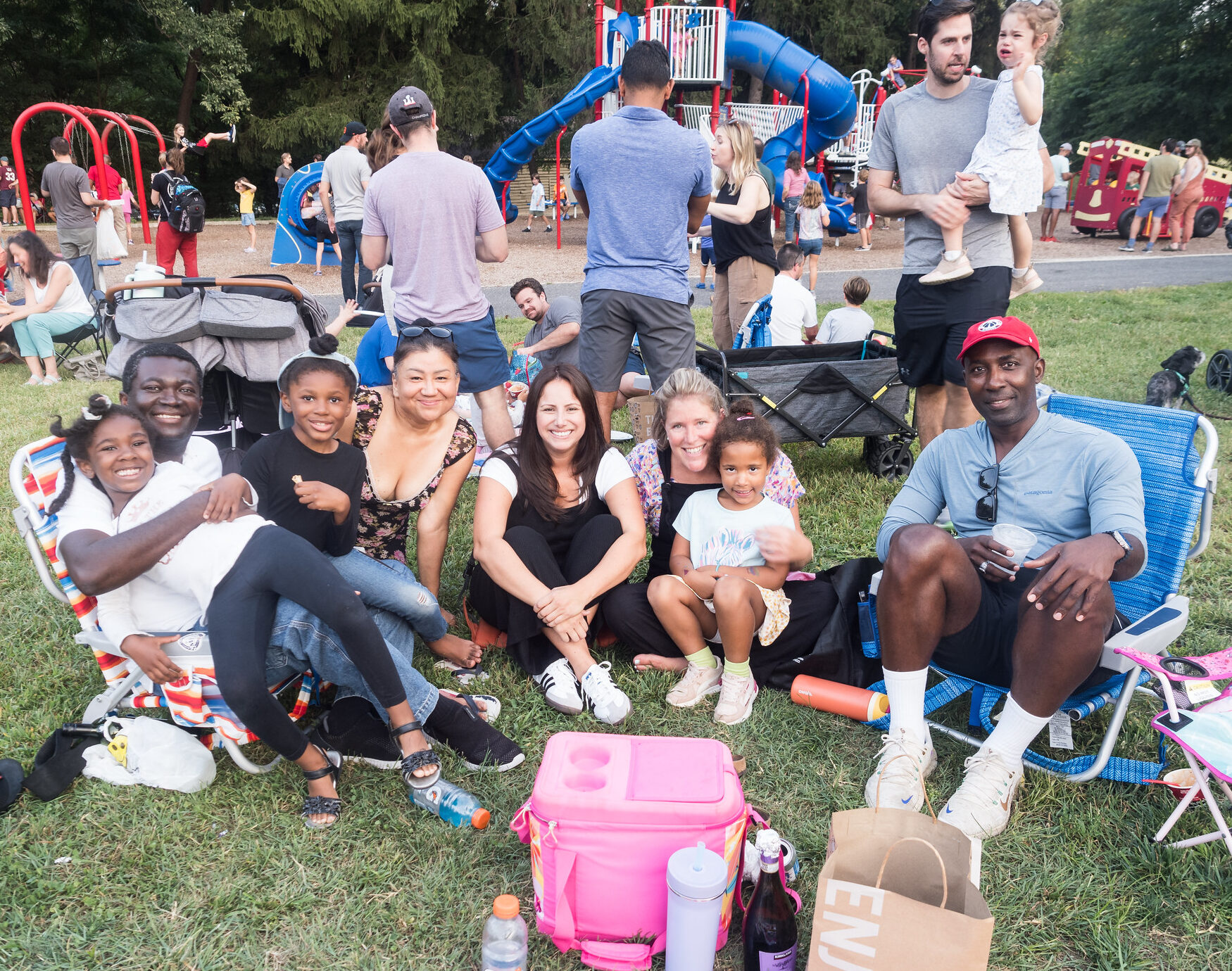 A group of people smiling at a park