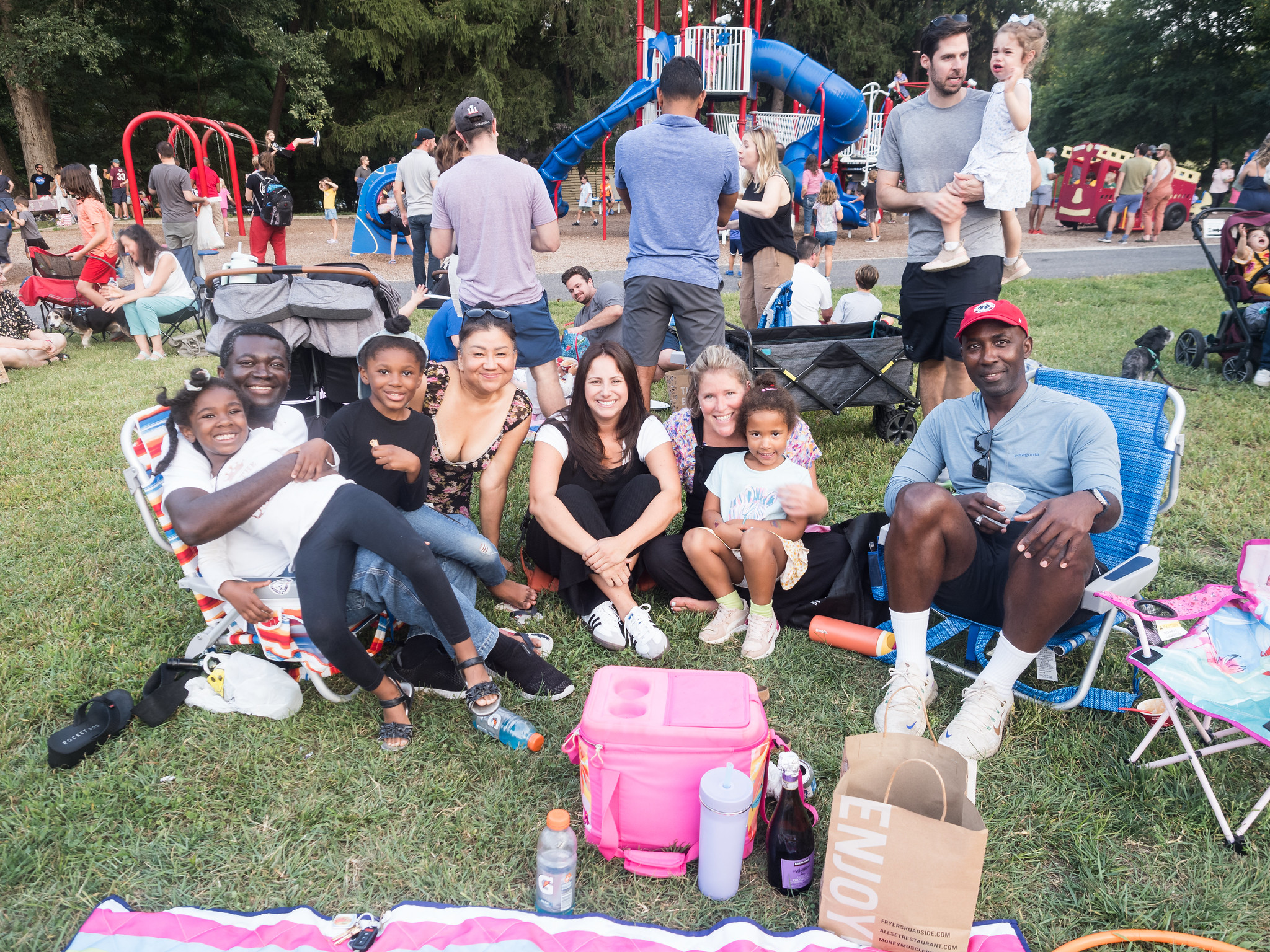 A group of people smiling at a park