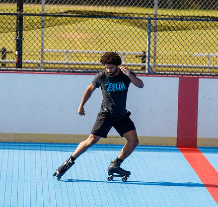 Man performs roller skating tricks on the rink