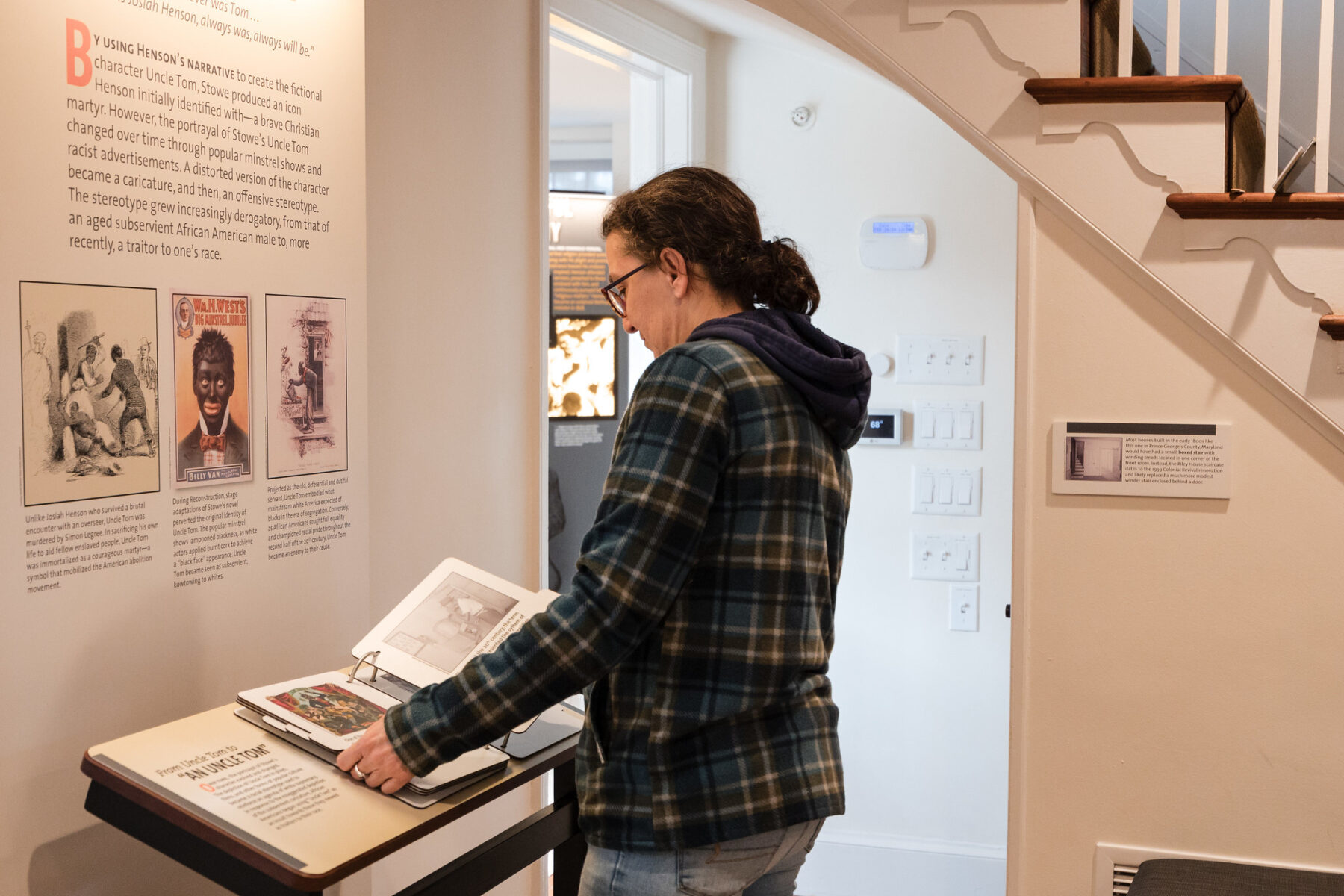 An adult looks at an exhibit at Josiah Henson Museum and Park