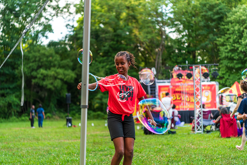 Young girl plays with big bubbles