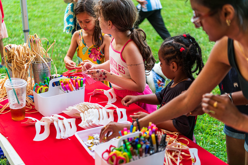 Kids making masks and wands using stars and colored pens