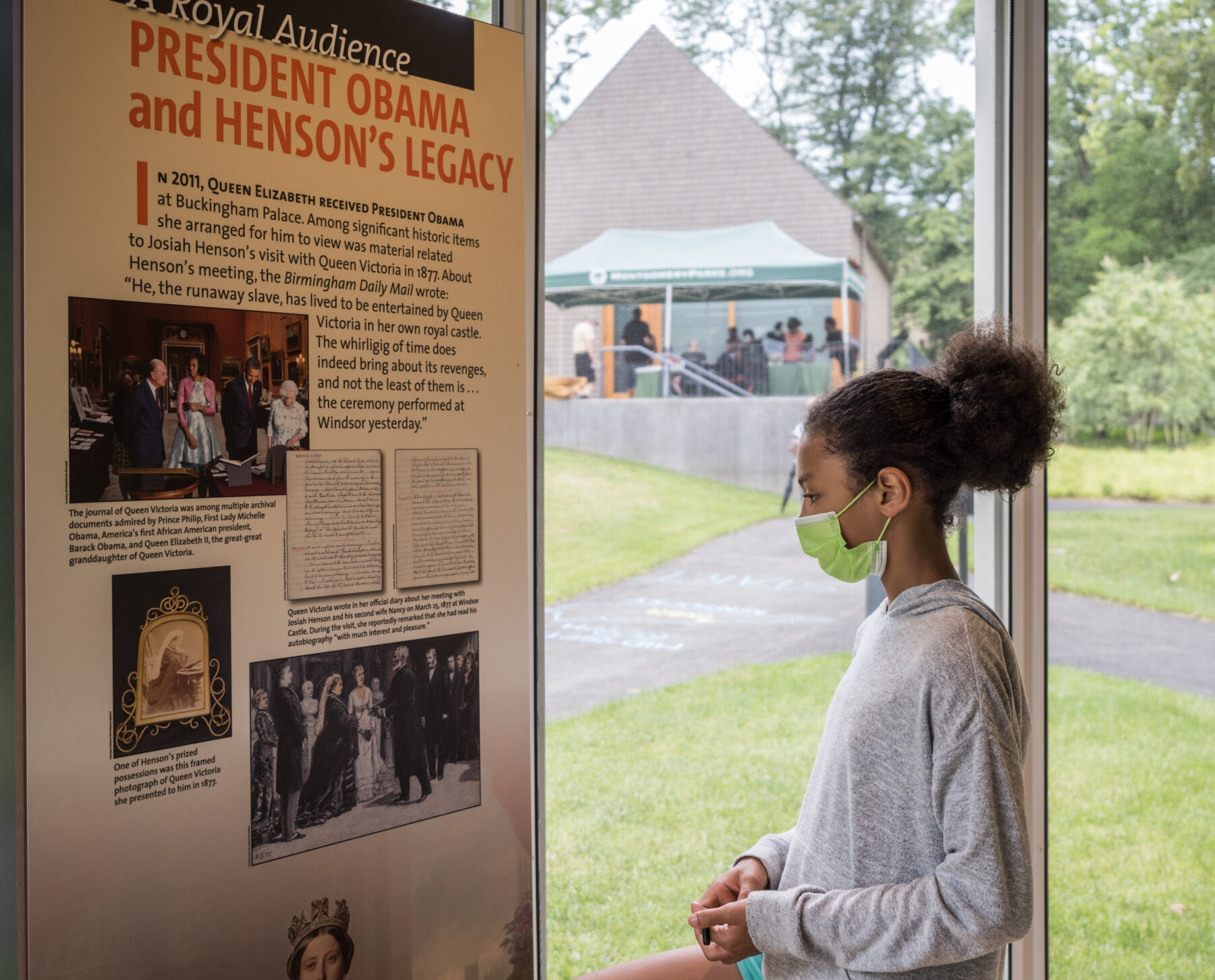 Girl reading interpretive text at Josiah Henson Museum and Park