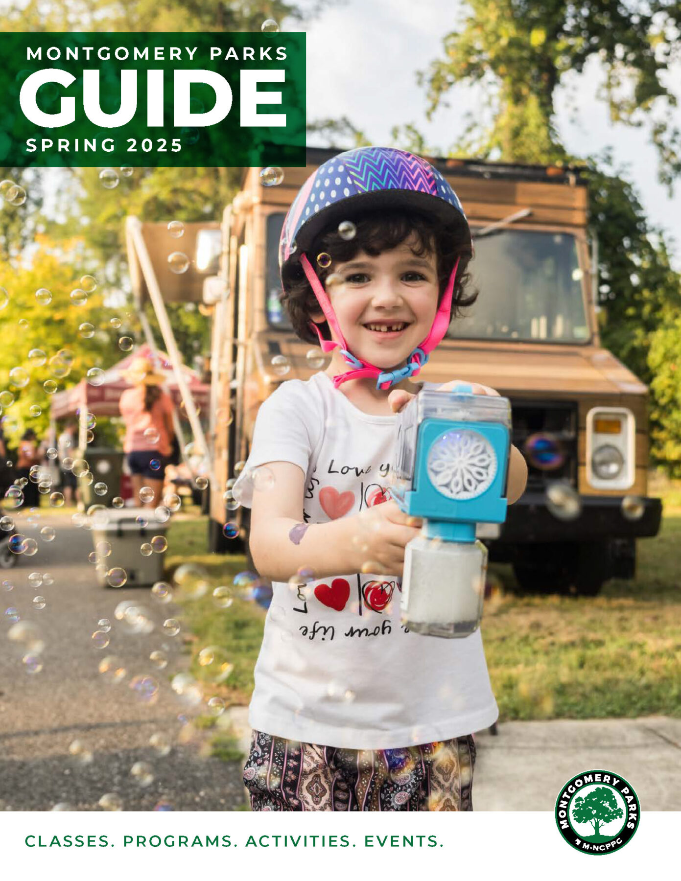 Child outdoors holding a bubble machine wearing a bike helmet. Text reads Montgomery Parks Guide Spring 2025. Classes, Programs, Activities, Events.