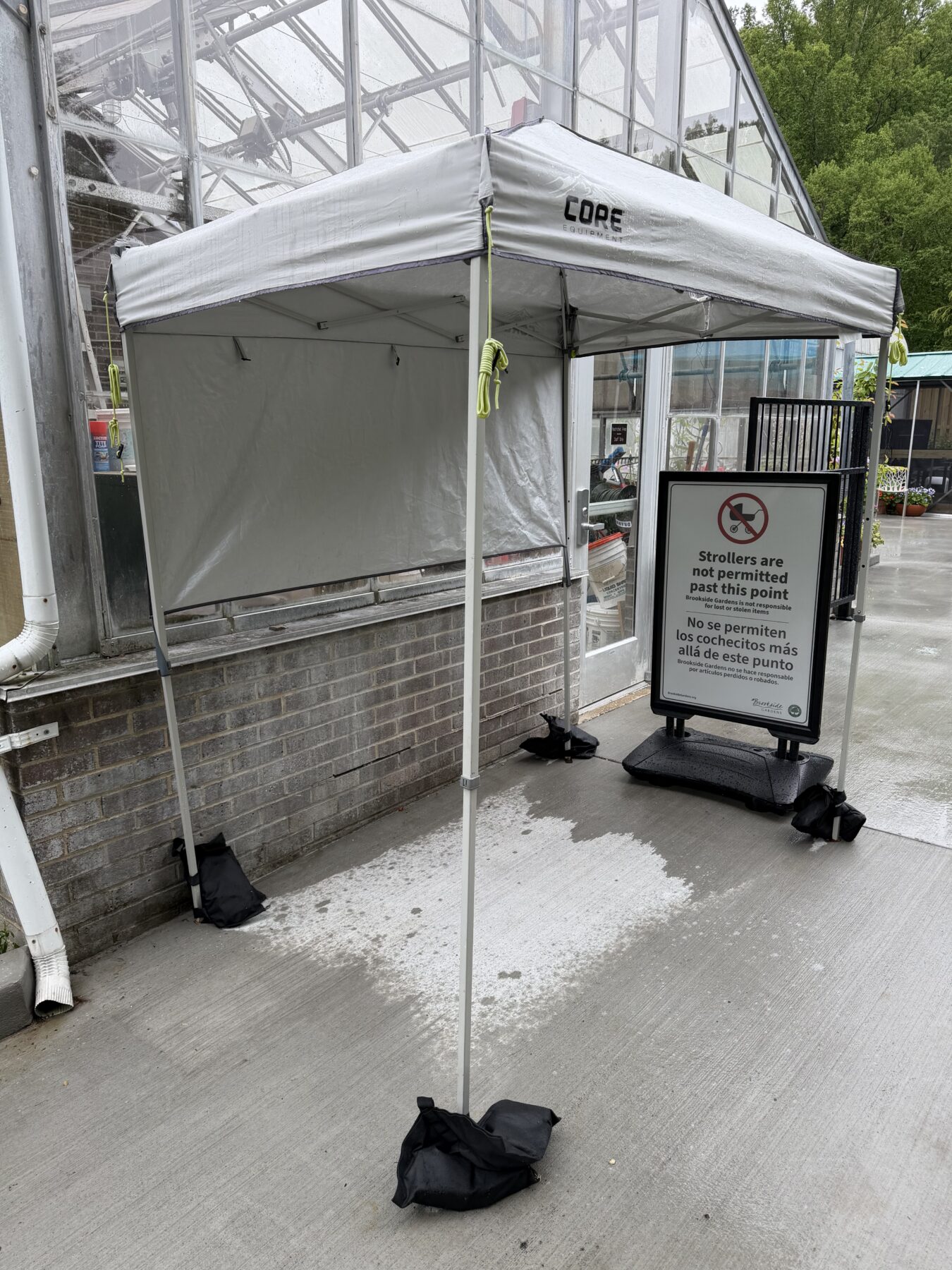 Tent next to the conservatory with a sign under stating no strollers allowed inside