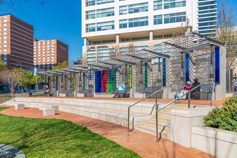 Side view of art installation at Gene Lynch Urban Park featuring panels creating a kaleidoscopic-colored effect.